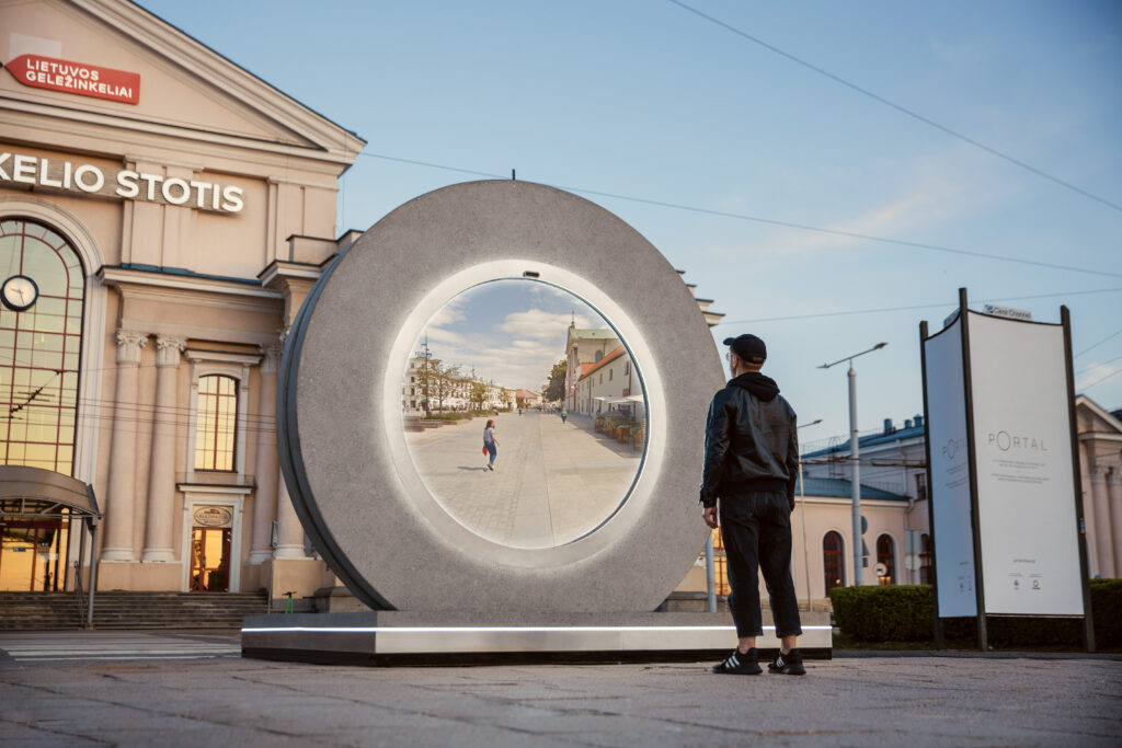 An onlooker stands in front of a Portal artwork.